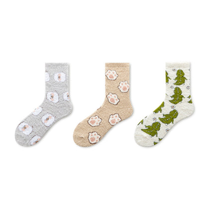 Stack of Rufia winter fleece socks in neutral colors on wooden surface