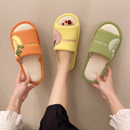 Pair of Slipeer fruit-themed indoor slippers in bright orange and green colors