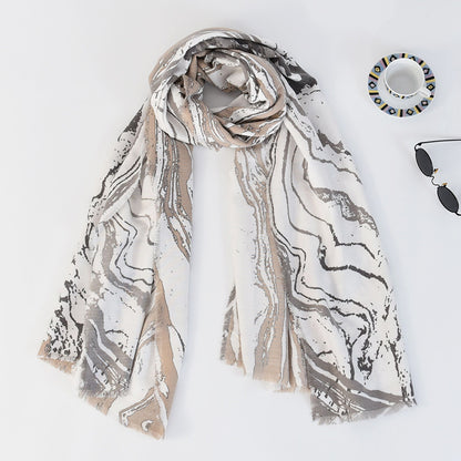 Model holding Scarvii marble long scarf showing soft fabric and marble print