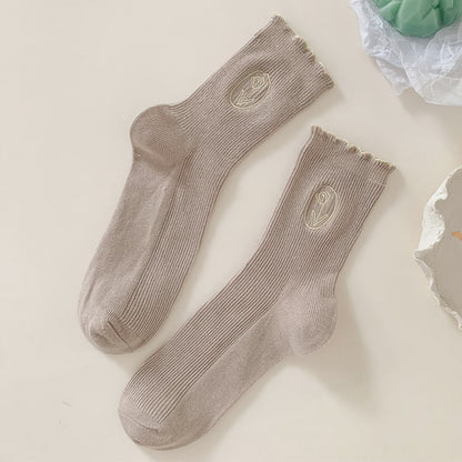 Five pairs of socks with creamy tulip print folded together