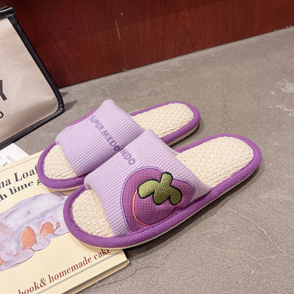 Green Slipeer indoor slipper angled to show sole and fruit design